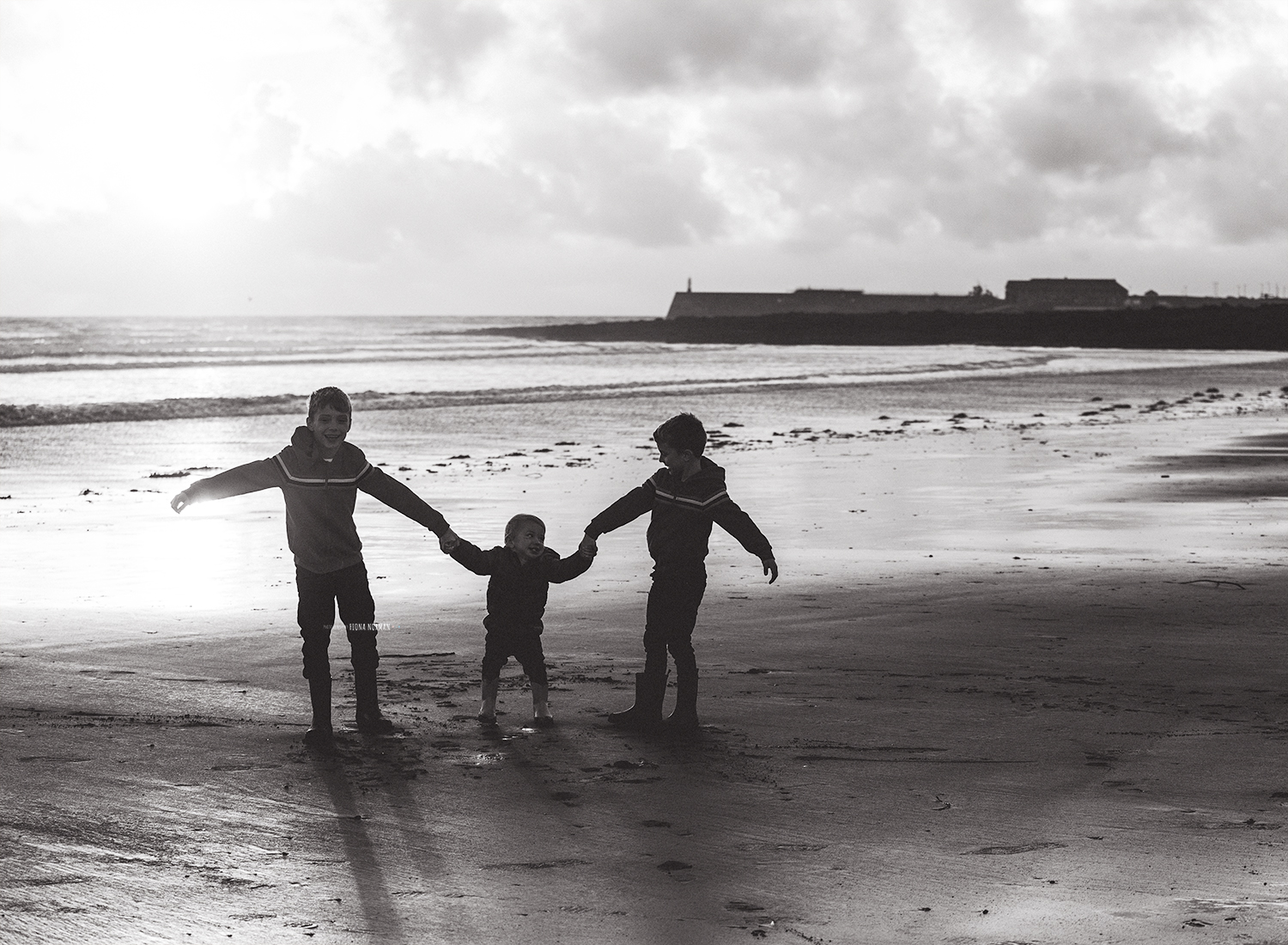 boys at beach holding hands